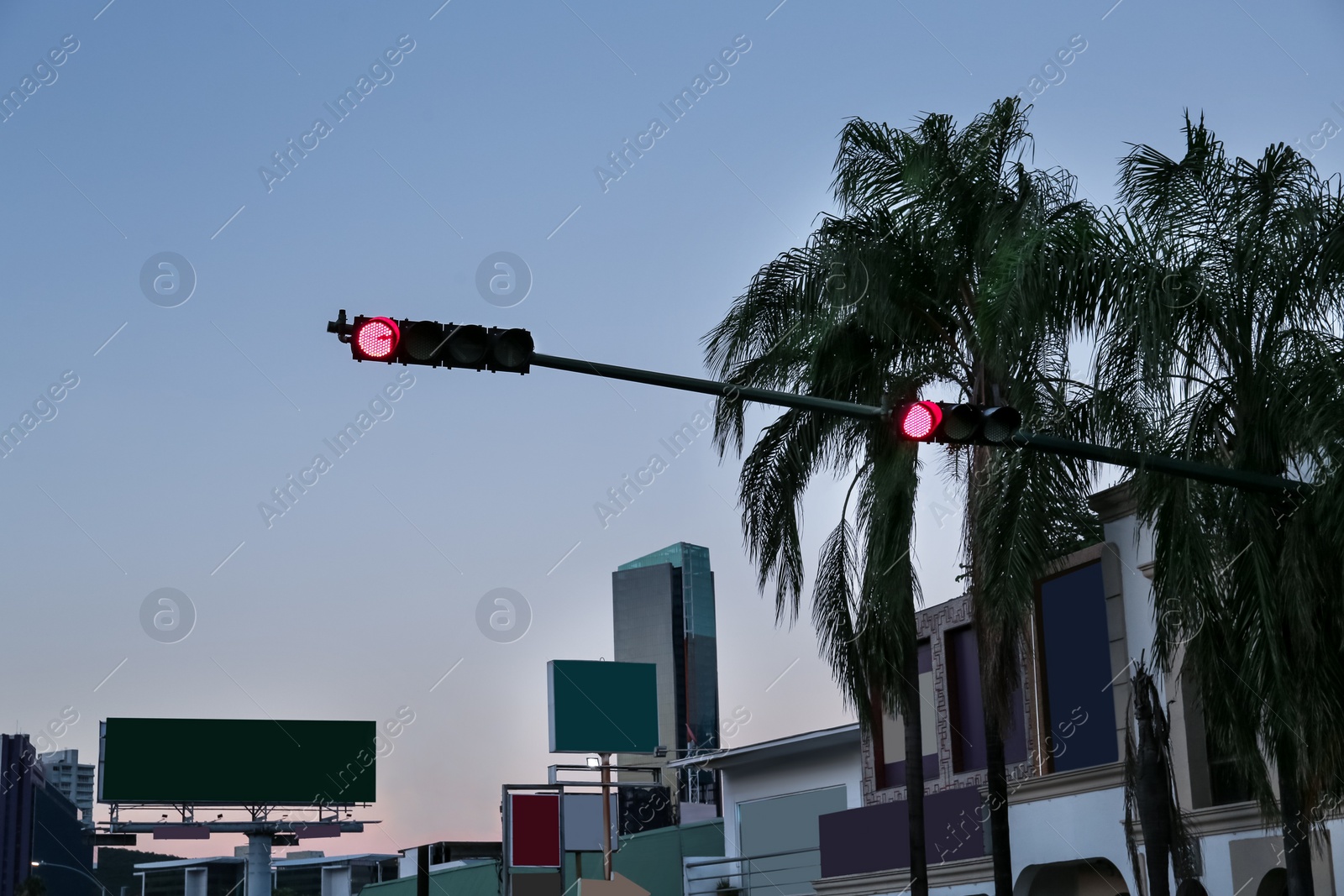 Photo of Post with red traffic light on city street