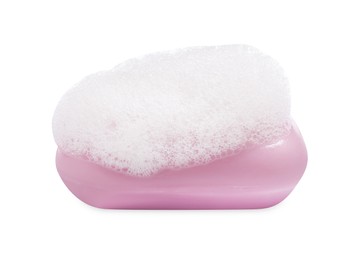 Soap bar with fluffy foam on white background