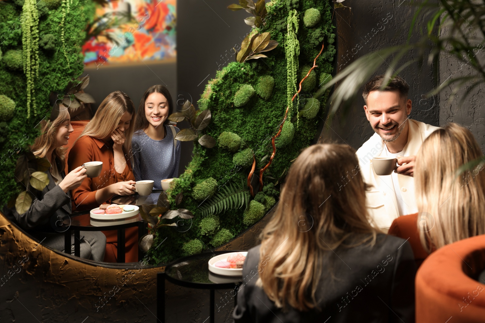 Photo of People with coffee spending time together in cafe