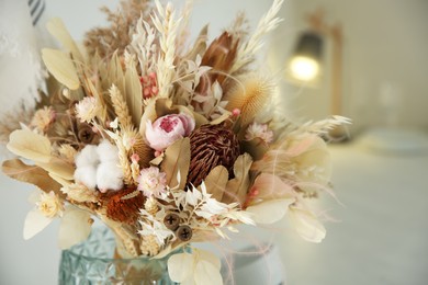 Photo of Bouquet of dry flowers and leaves on blurred background