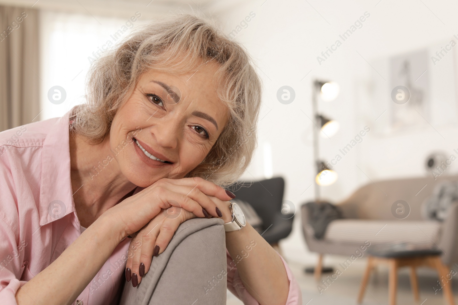 Photo of Portrait of mature woman in living room