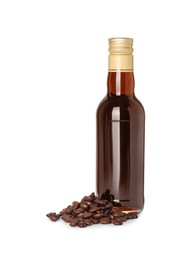Photo of Bottle of delicious syrup for coffee and beans isolated on white