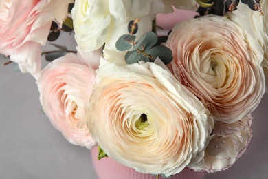 Beautiful delicate spring ranunculus flowers on color background, closeup