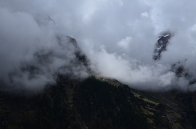 Picturesque view of mountains covered with fog