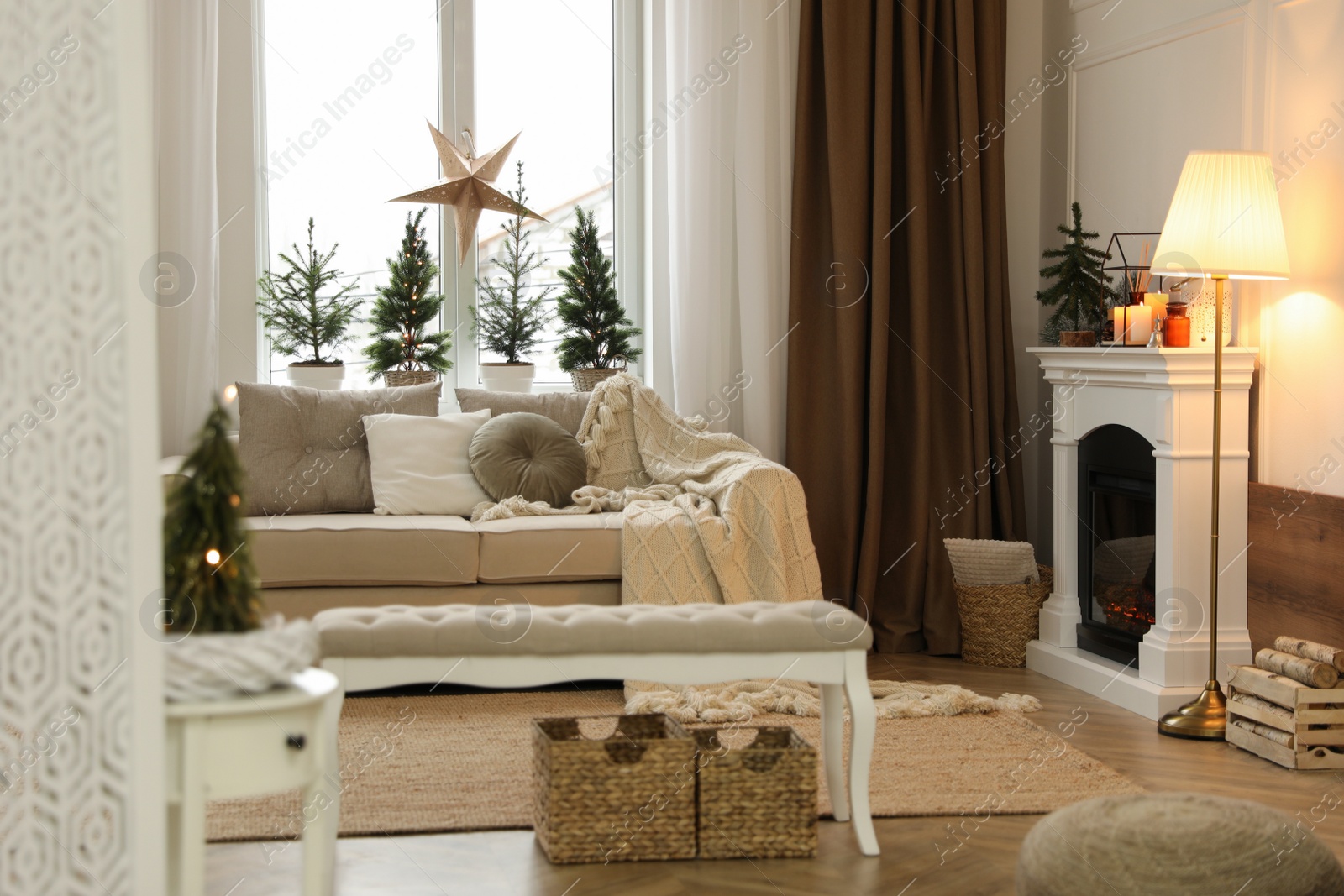 Photo of Fireplace in room with Christmas decorations. Interior design