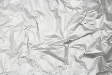 Photo of Crumpled silver foil as background, top view