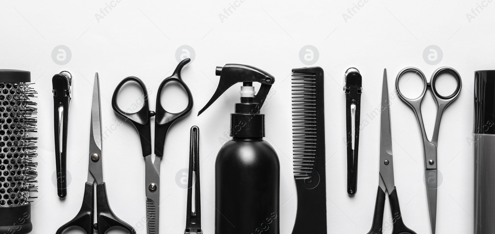 Image of Set with scissors and other hairdresser's accessories on white background, flat lay. Banner design