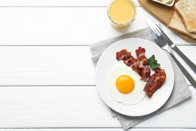 Delicious breakfast with sunny side up egg served on white wooden table, flat lay. Space for text