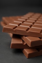 Tasty chocolate bars on grey table, closeup