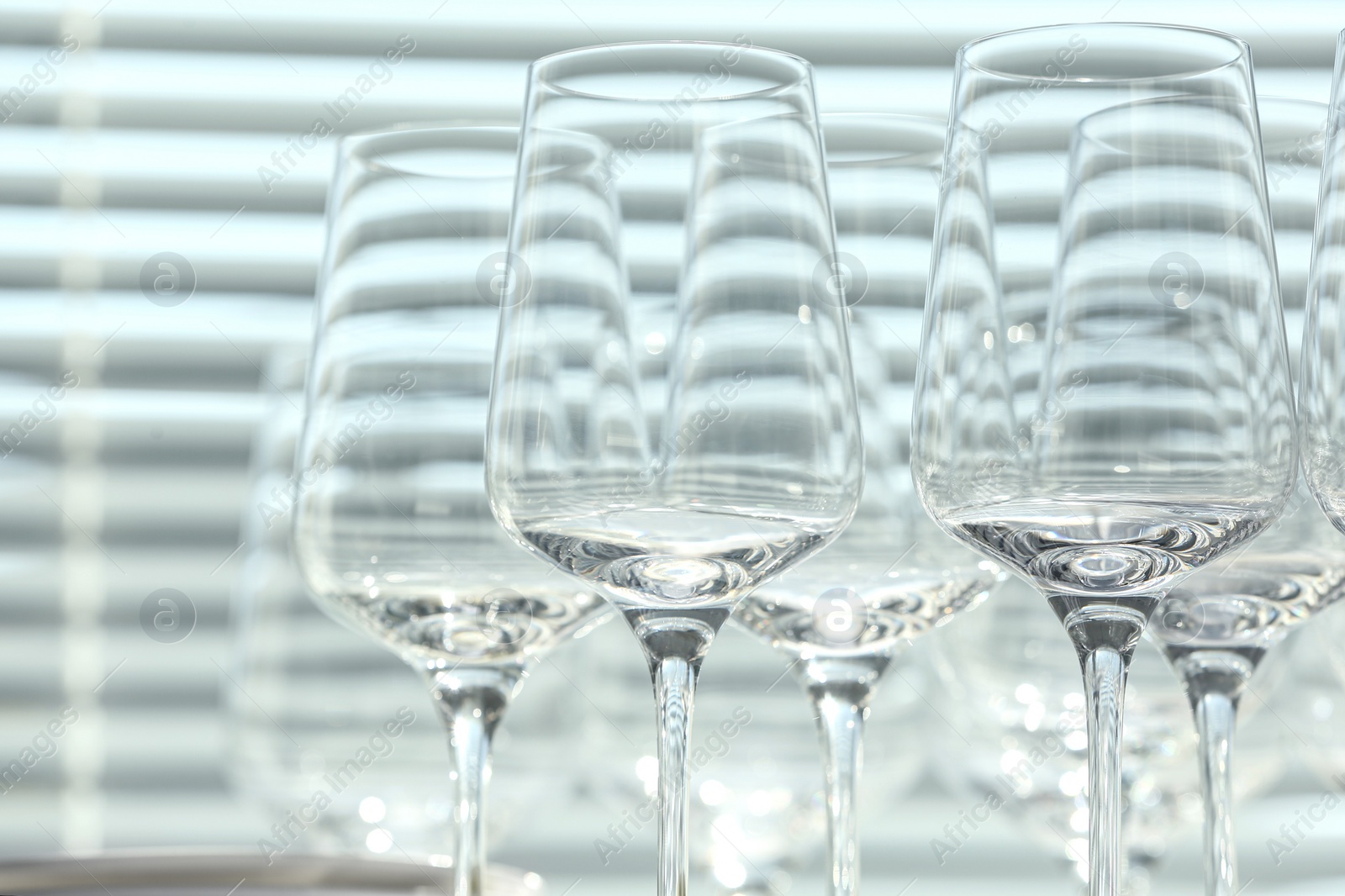 Photo of Set of empty wine glasses on blurred background, closeup