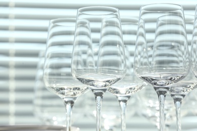 Photo of Set of empty wine glasses on blurred background, closeup