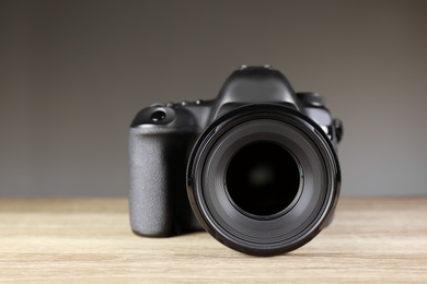 Photo of Digital camera of professional photographer on table