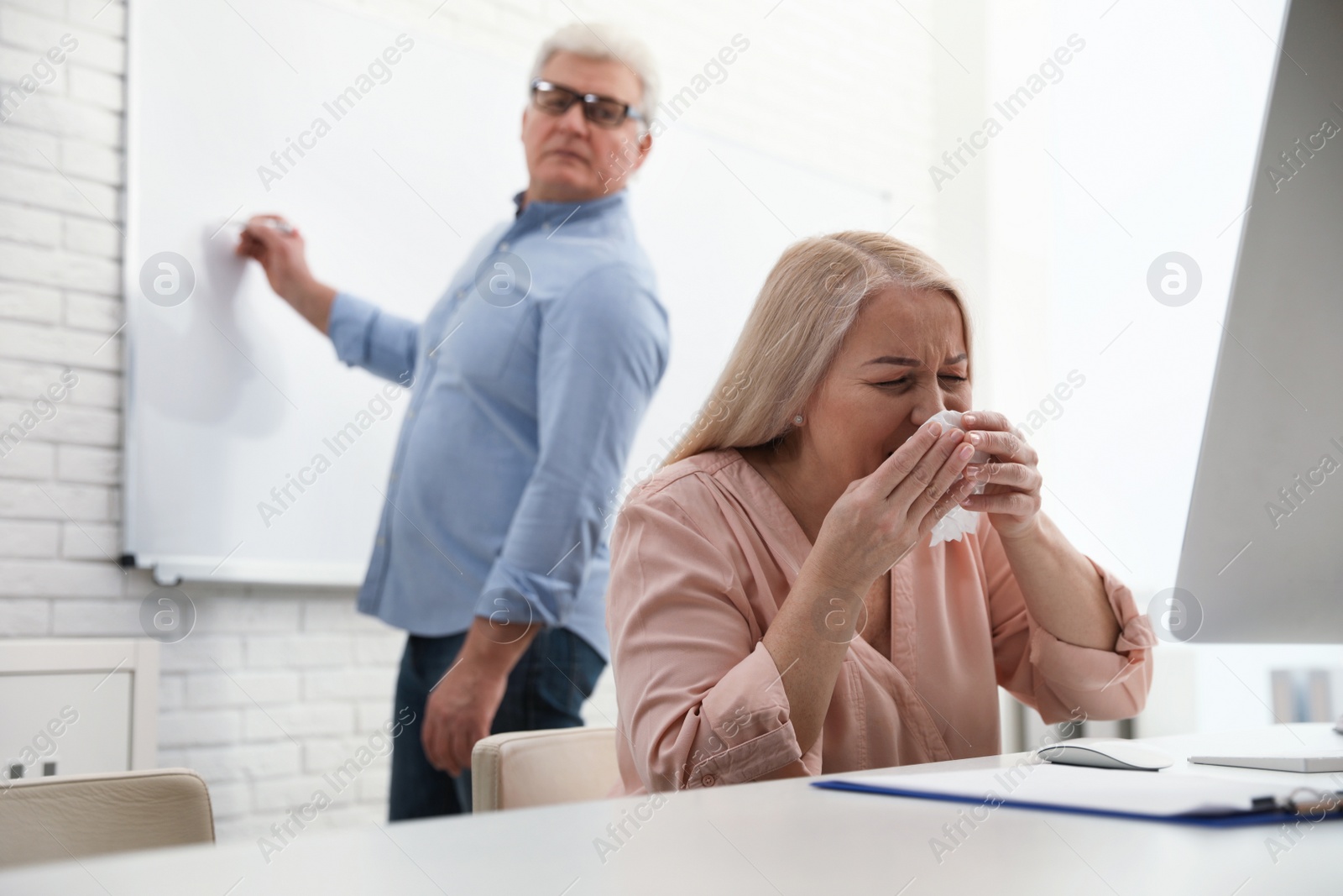 Photo of Sick mature woman at workplace. Dangerous virus