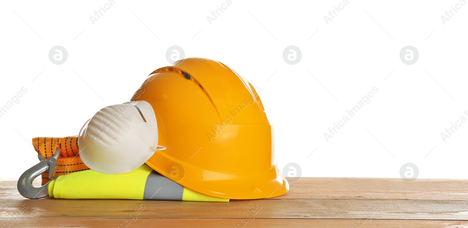 Photo of Set of safety equipment on table against white background