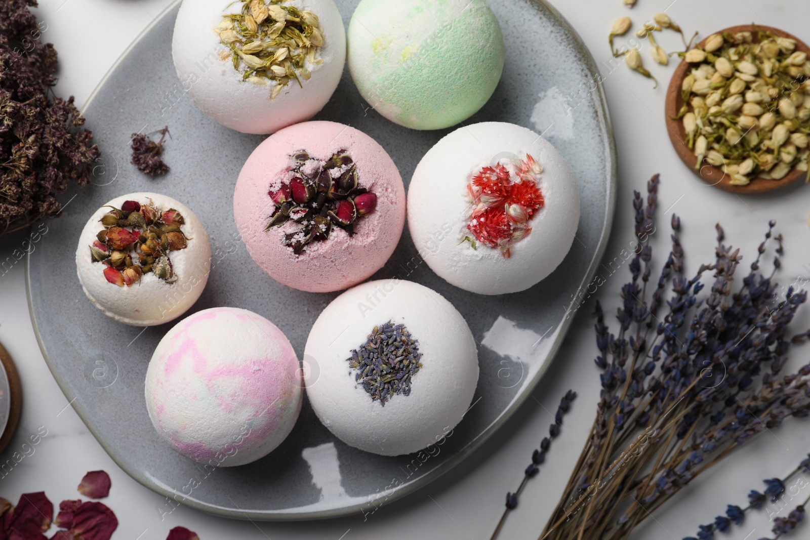 Photo of Flat lay composition with bath bombs and ingredients on light table