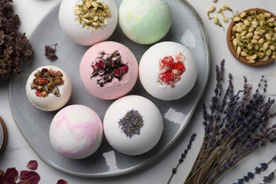 Photo of Flat lay composition with bath bombs and ingredients on light table