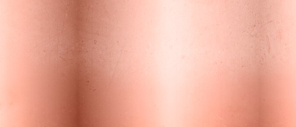 Rose gold surface as background, closeup view