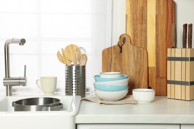 Countertop with sink and cooking utensils in kitchen