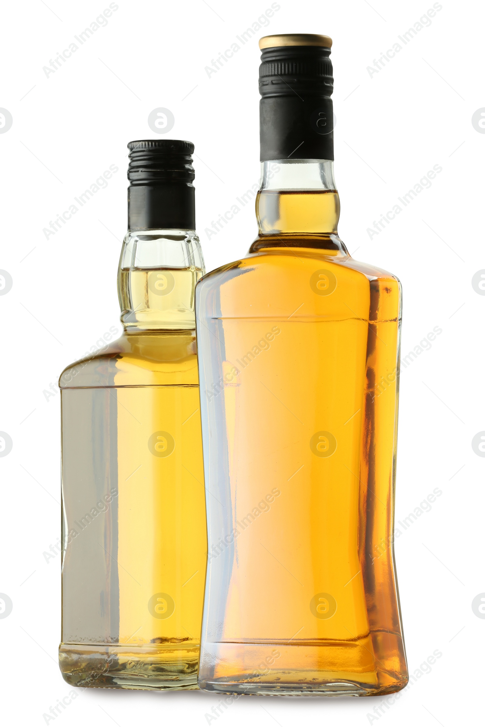 Photo of Different sorts of whiskey in glass bottles isolated on white