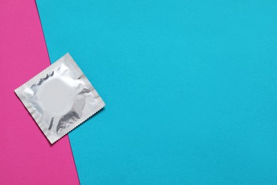 Condom package on color background, top view and space for text. Safe sex