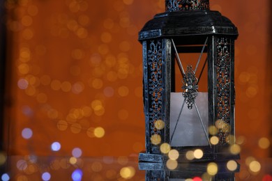 Photo of Arabic lantern against blurred lights, space for text