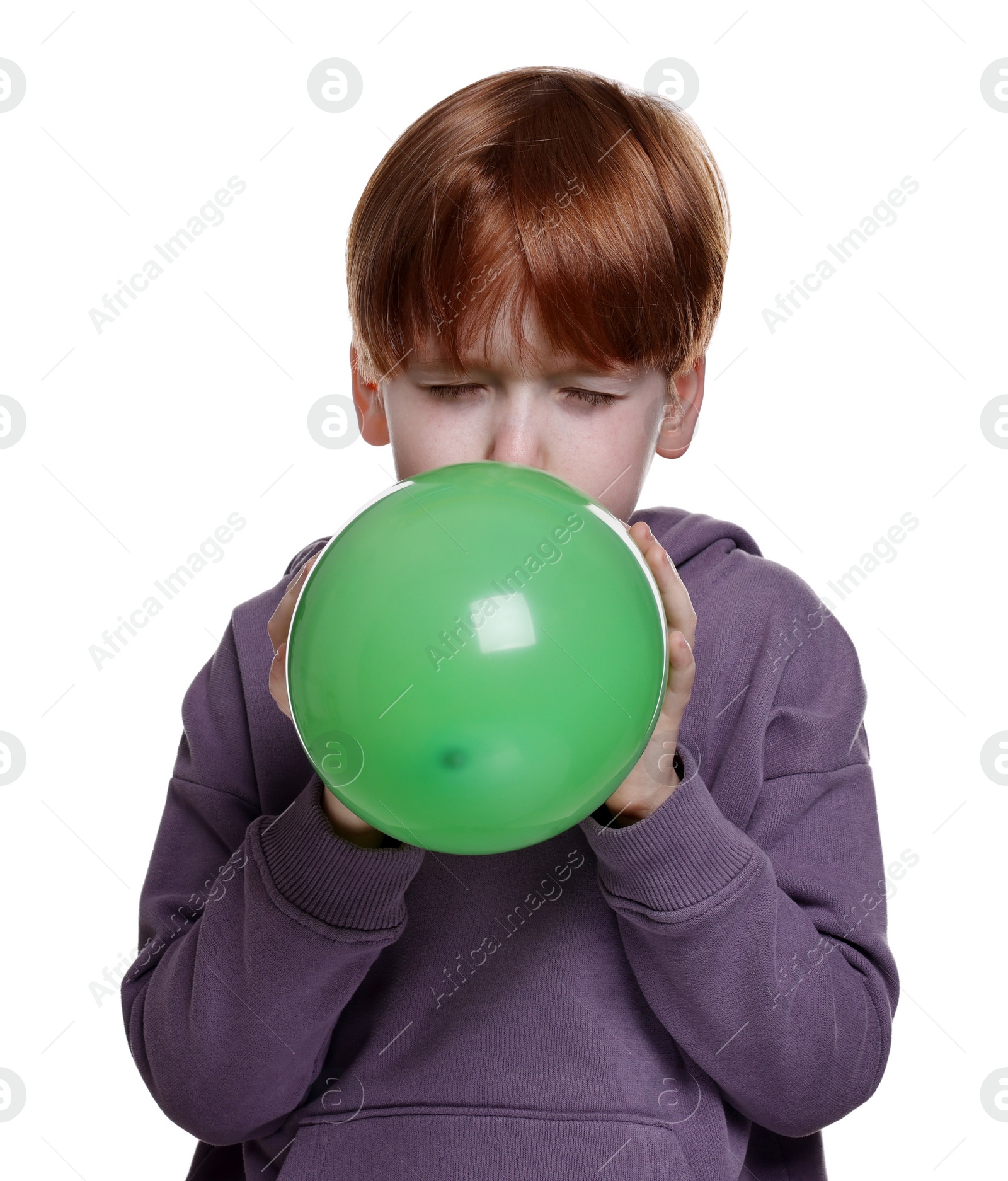 Photo of Boy inflating green balloon on white background