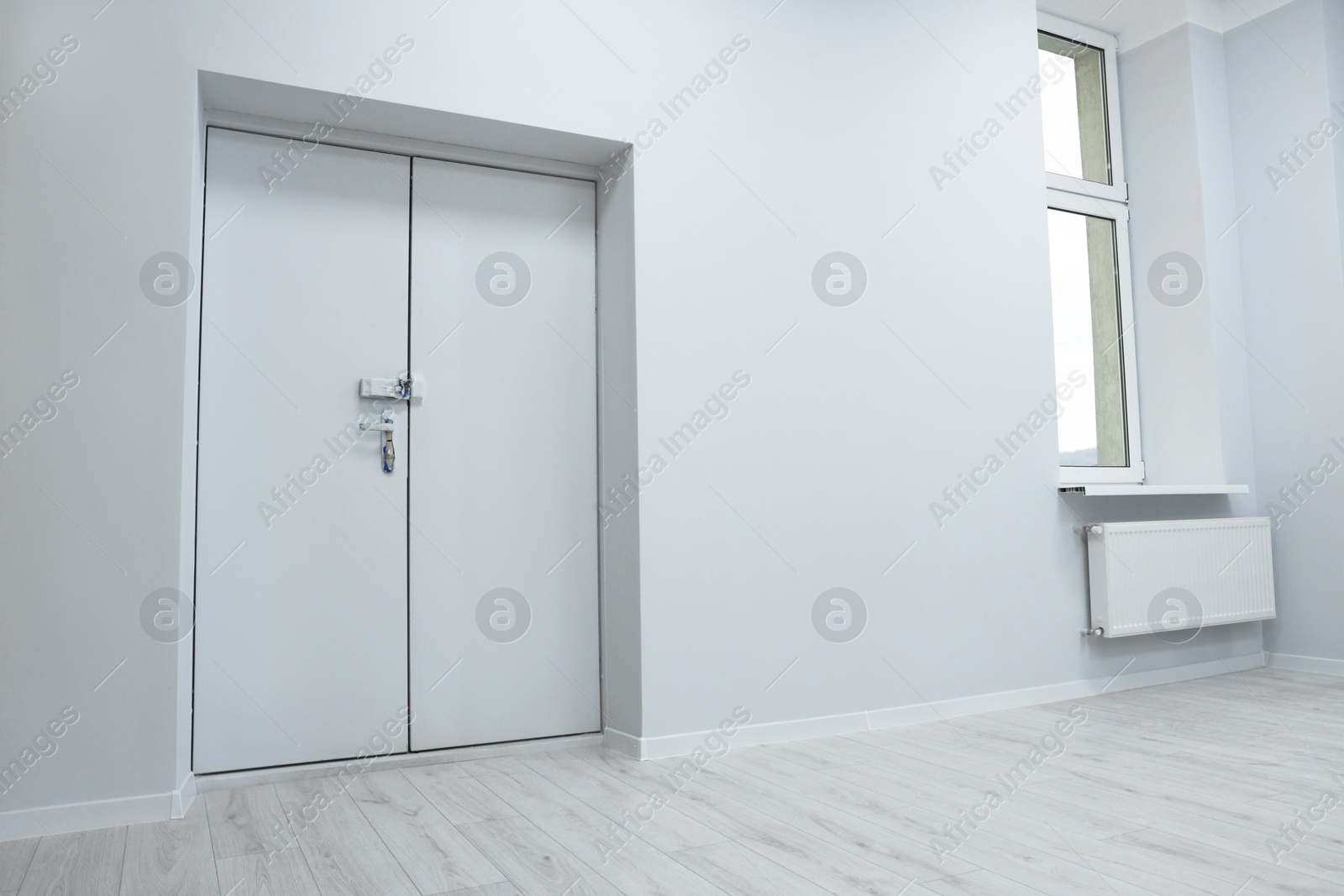 Photo of Empty renovated room with door and window