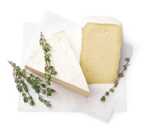 Photo of Piece of tasty camembert cheese and thyme isolated on white, top view