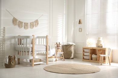 Photo of Baby room interior with stylish furniture and toys