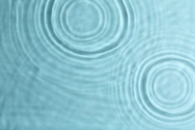 Photo of Closeup view of water with circles on turquoise background