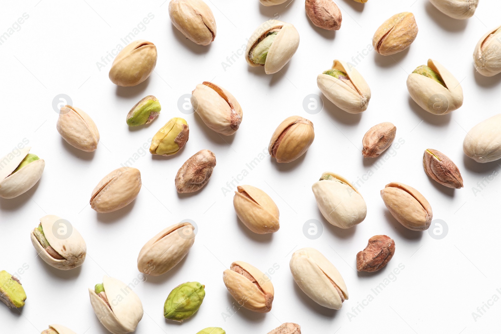 Photo of Composition with organic pistachio nuts on white background, top view