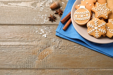 Flat lay composition with tasty homemade Christmas cookies on wooden table, space for text