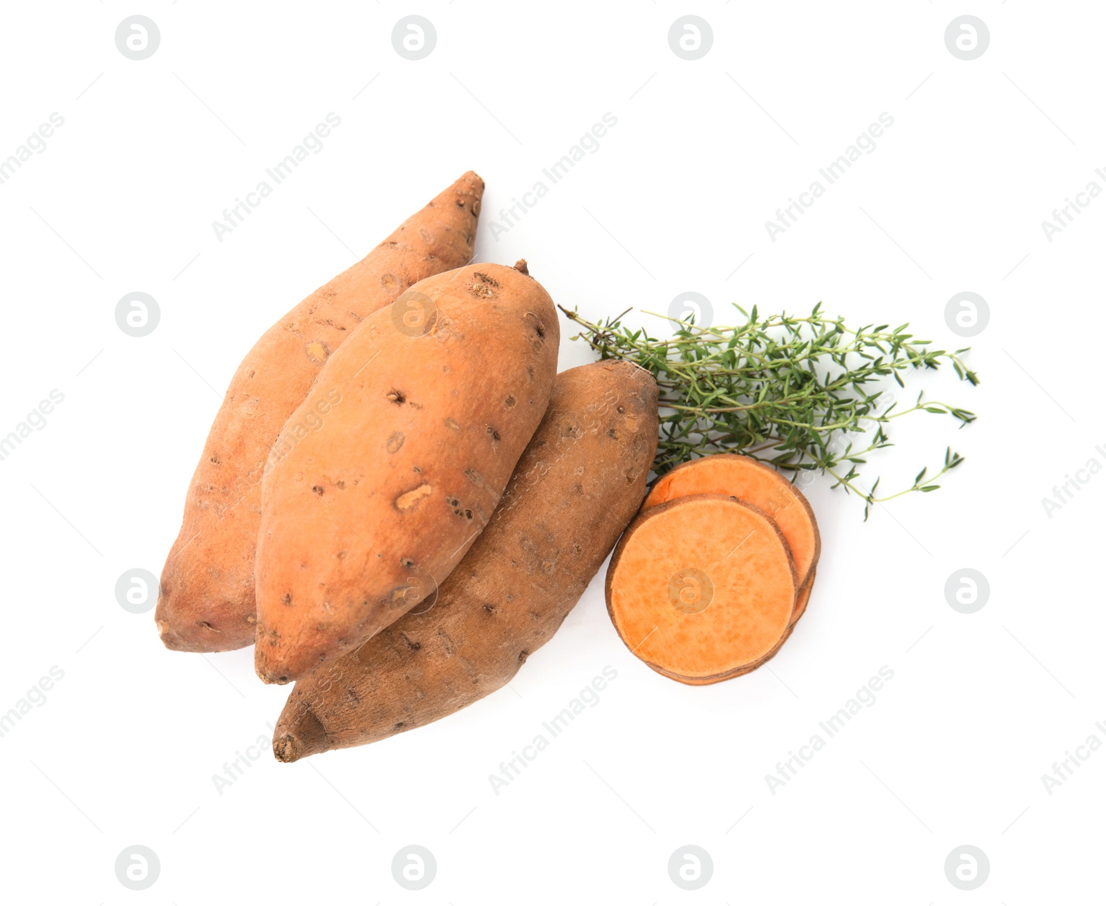 Photo of Cut and whole sweet potatoes with thyme on white background, top view