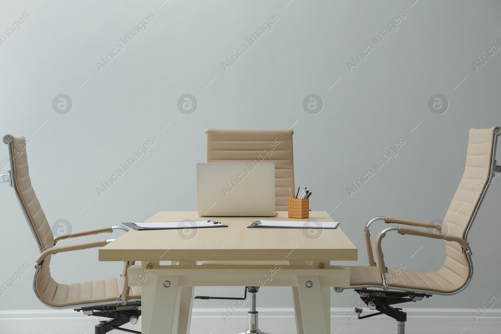 Photo of Director's office with large wooden table and comfortable armchairs. Interior design