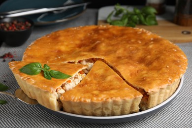 Photo of Delicious meat pie with basil on table, closeup