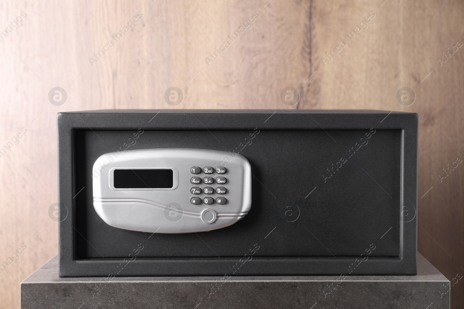 Photo of Black steel safe with electronic lock on grey table