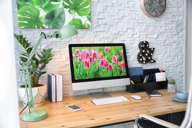 Stylish workplace with computer on table