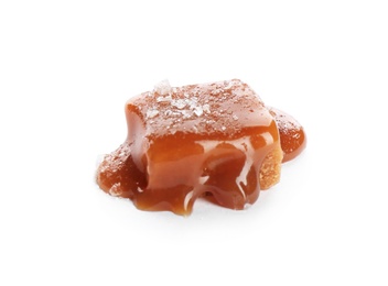 Delicious candy with caramel sauce and salt on white background