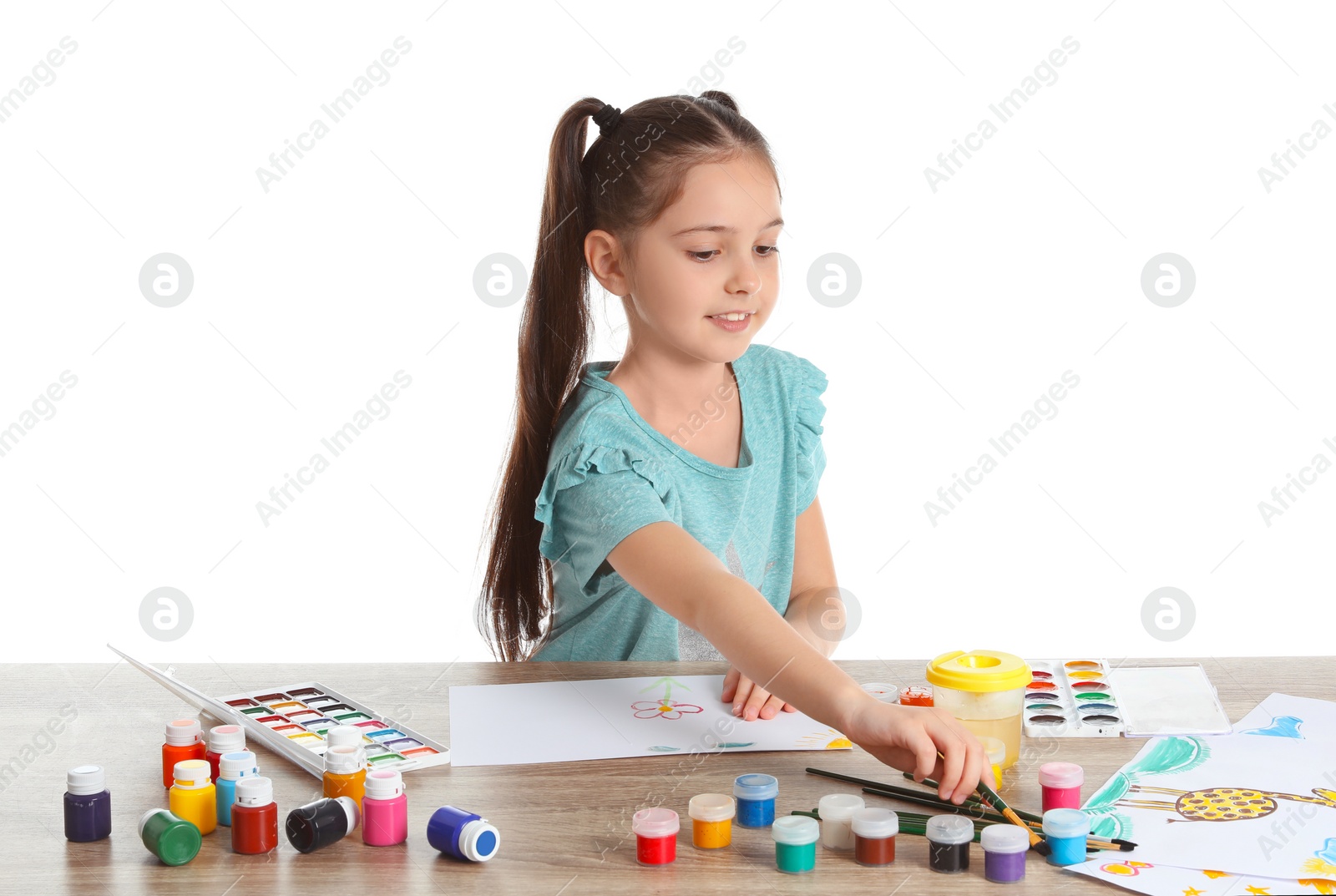 Photo of Cute child painting picture at table on white background