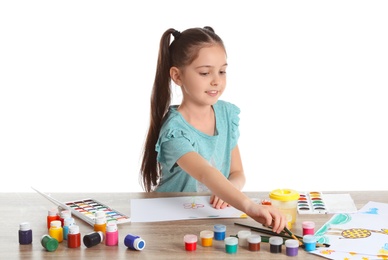 Photo of Cute child painting picture at table on white background