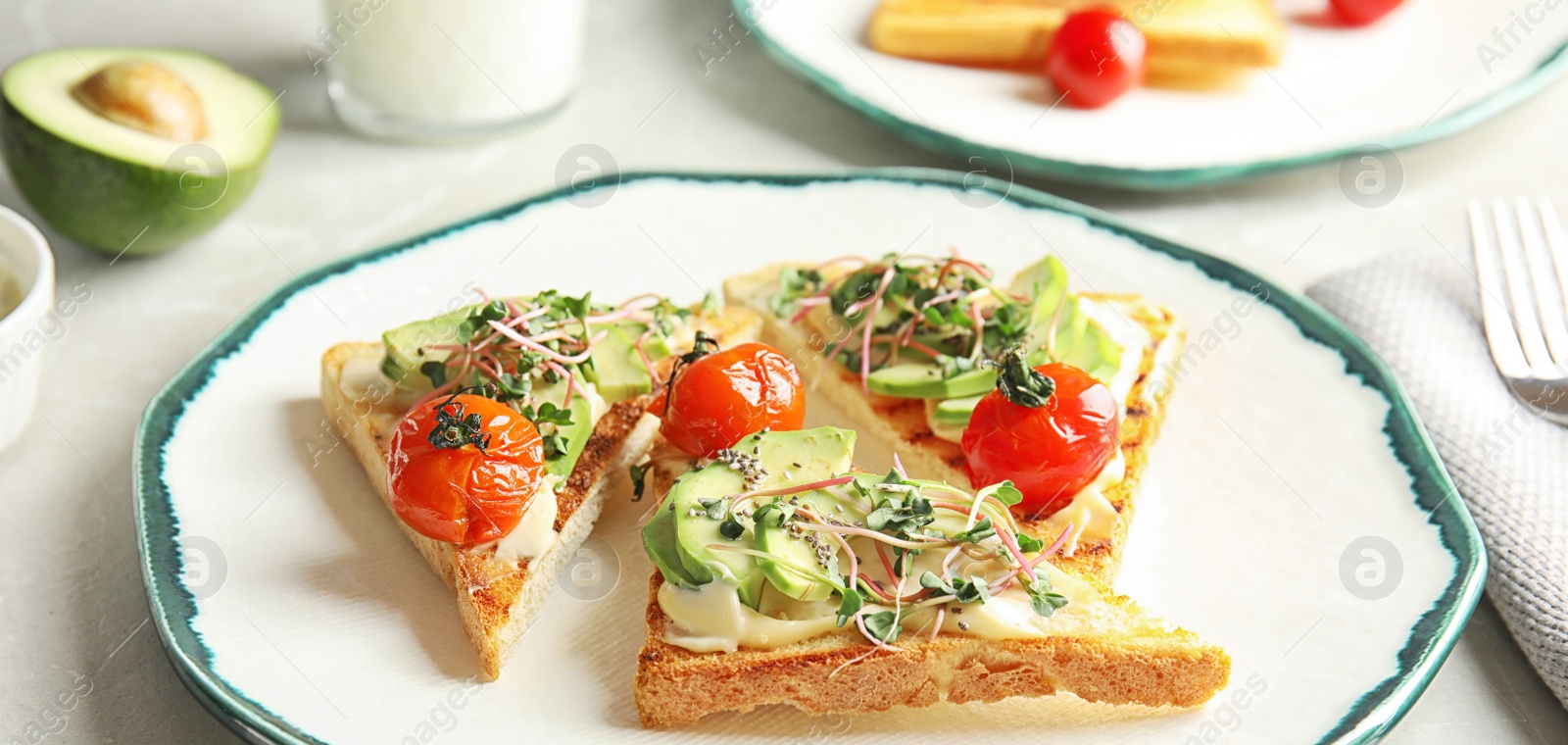 Image of Tasty bruschettas with avocado, tomatoes and chia seeds on plate, banner design 