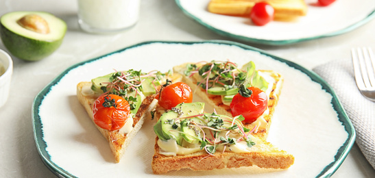 Image of Tasty bruschettas with avocado, tomatoes and chia seeds on plate, banner design 