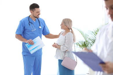 Doctor talking with patient in hospital hall