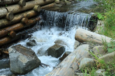 Photo of View of river flowing near rocks in forest