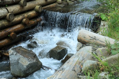 View of river flowing near rocks in forest