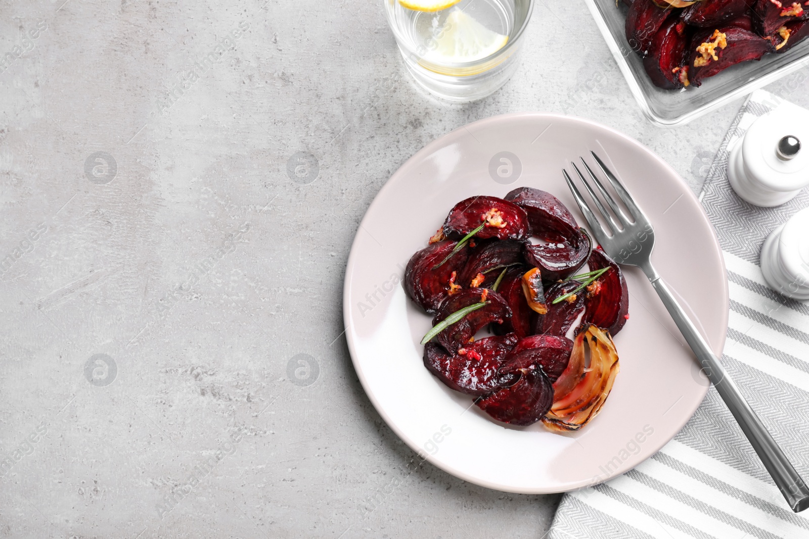 Photo of Roasted beetroot slices served on light grey table, flat lay. Space for text