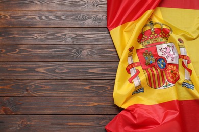 Flag of Spain on dark wooden background, top view. Space for text