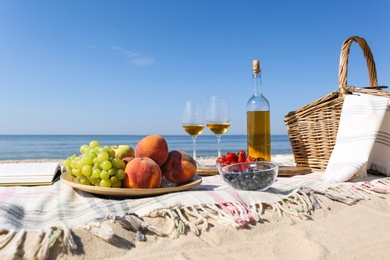Photo of Food and wine on beach. Summer picnic