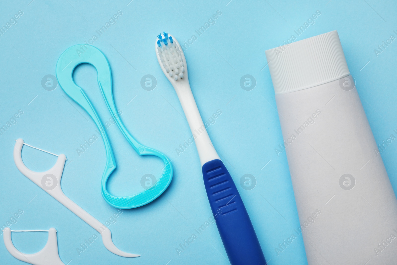 Photo of Flat lay composition with tongue cleaner and teeth care products on color background