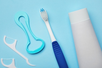 Photo of Flat lay composition with tongue cleaner and teeth care products on color background